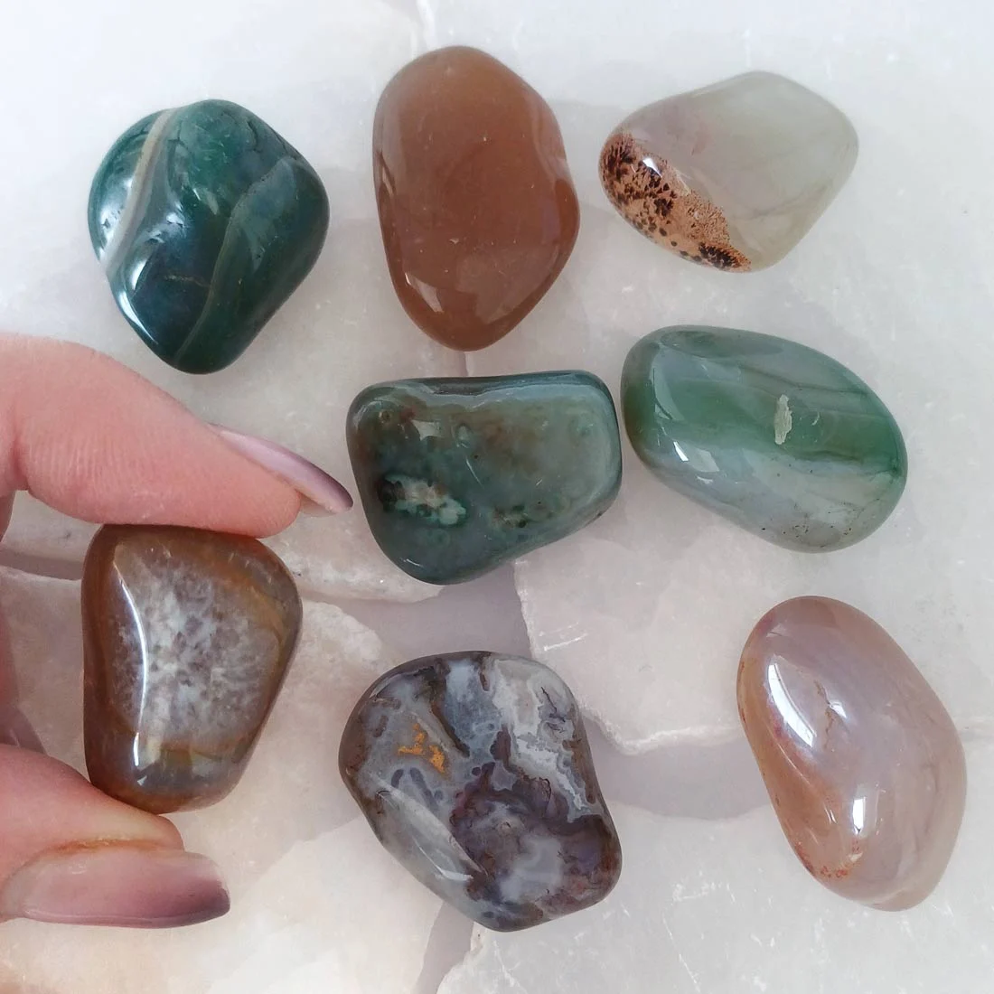 Natural Agate tumbled stone with soft earthy tones and unique internal patterns. Supports grounding, patience, and calm emotional balance.