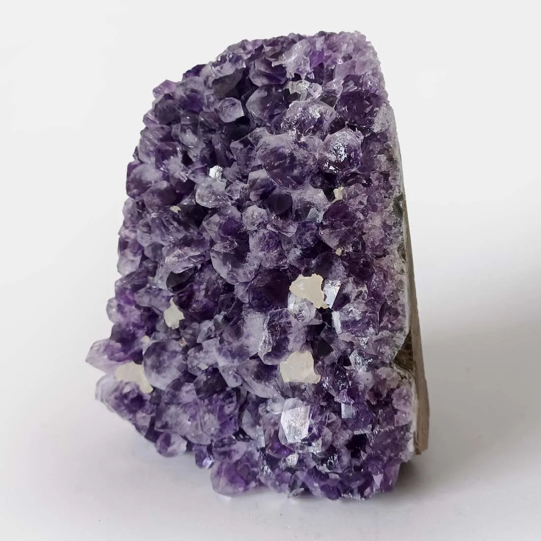 Premium Quality Amethyst Cluster from Uruguay with deep purple crystal points, freestanding flat-cut base, natural rough formation, healing crystal specimen for home décor, meditation space, and crystal collection.