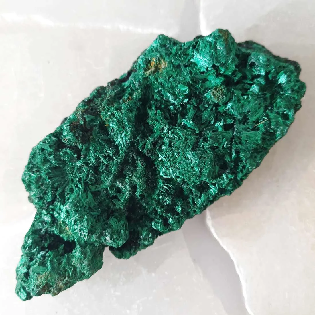 Fibrous malachite from Congo with deep green banding. A copper carbonate crystal formed in natural deposits, valued for its structure and geological origin.