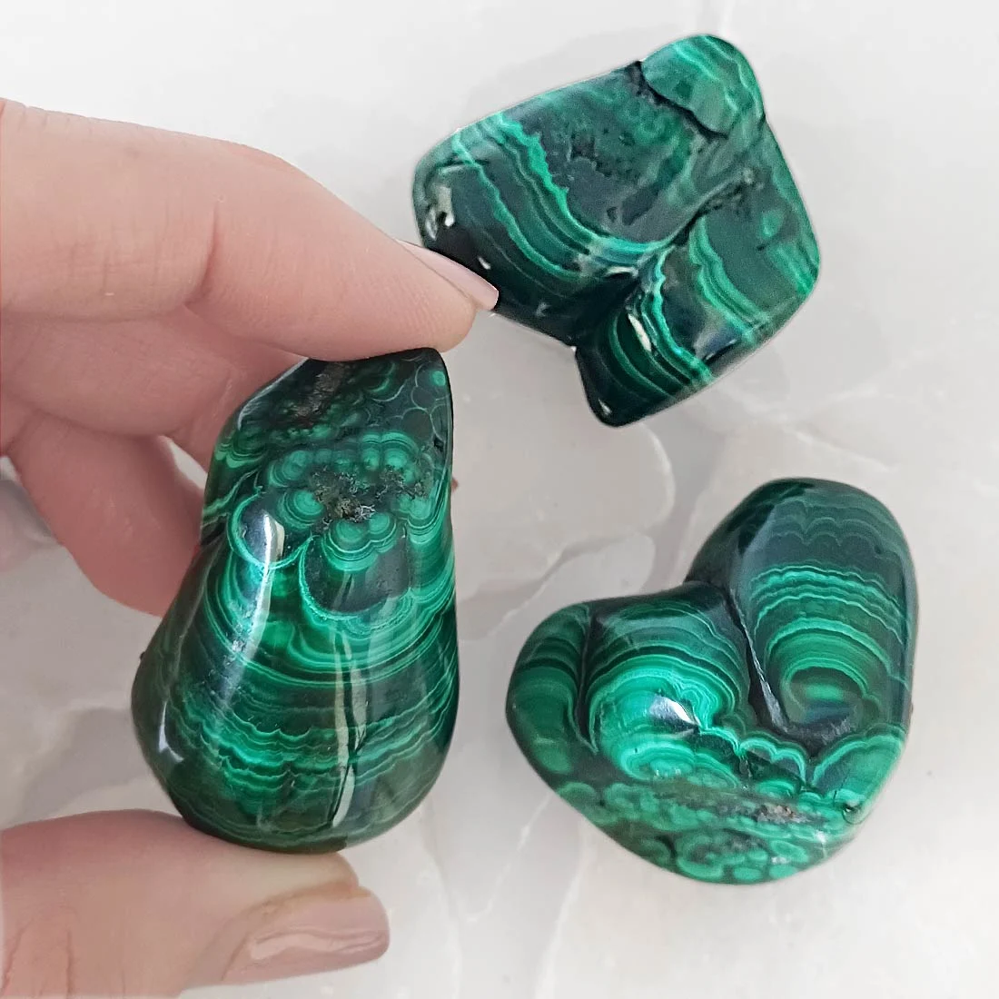Polished malachite with rich green banding. A copper carbonate crystal