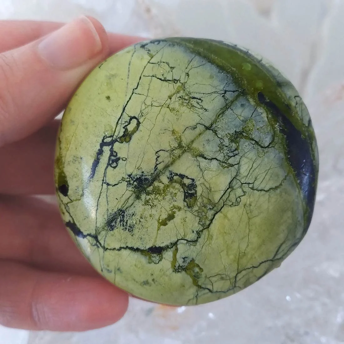 olished Serpentine palm stone from Peru with natural green colour variations and mottled mineral patterns