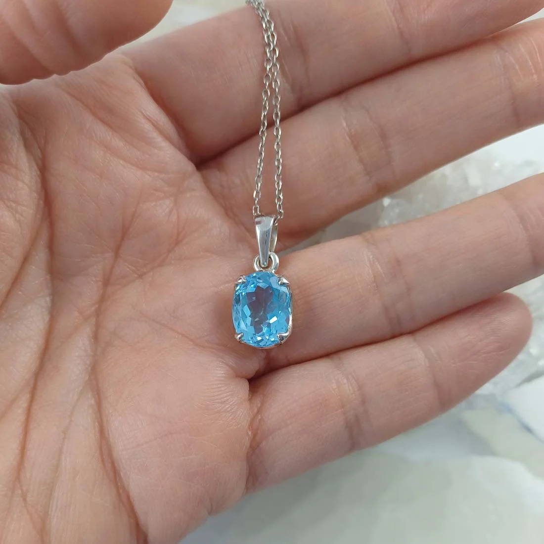Oval faceted Blue Topaz pendant set in 925 sterling silver