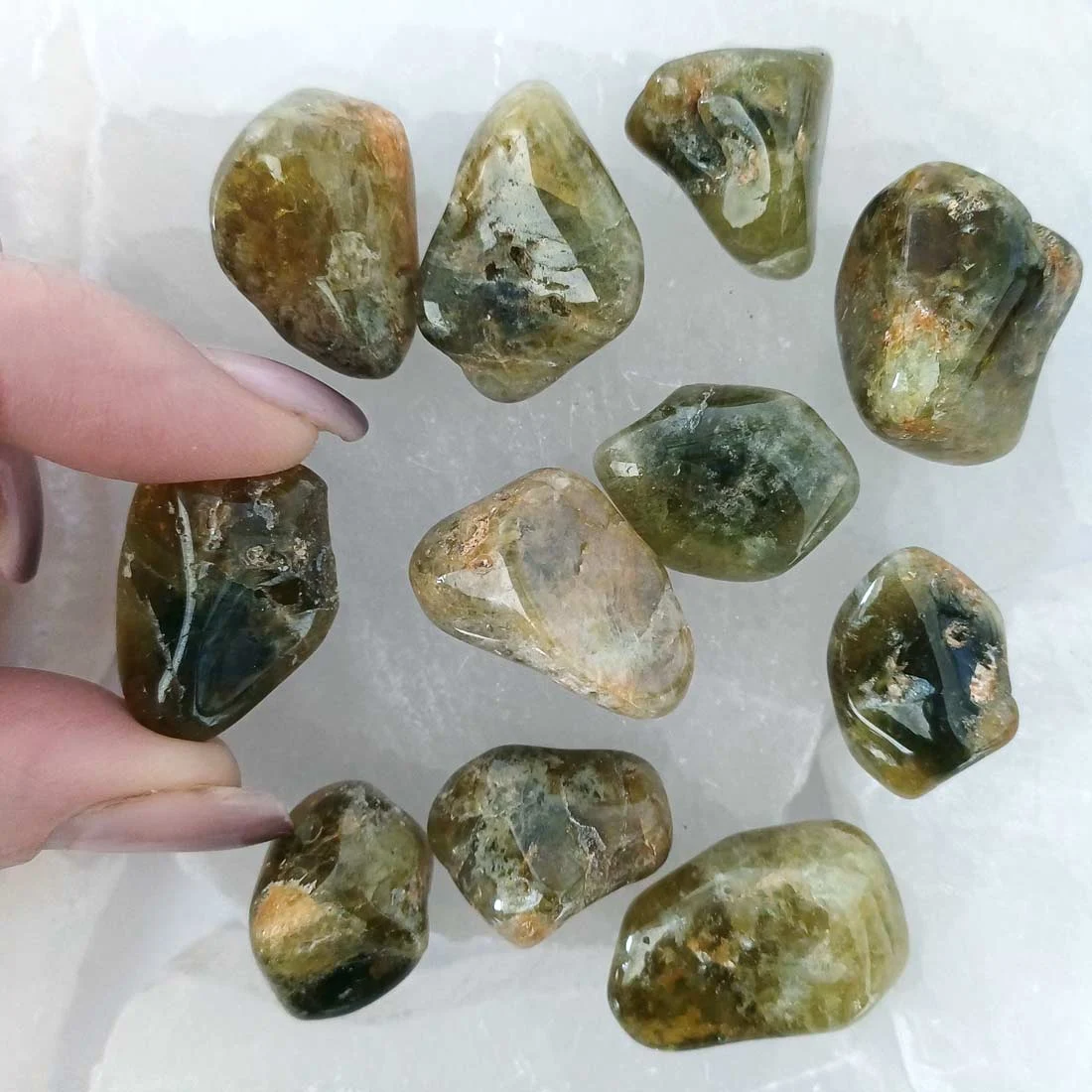 Polished Green Garnet tumbled stone with rich green tones, natural crystal associated with abundance, vitality, and emotional balance.