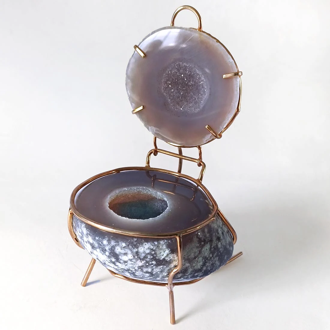 Agate crystal jewelry box with gold-tone metal frame and hinged lid showing natural banding and druzy center