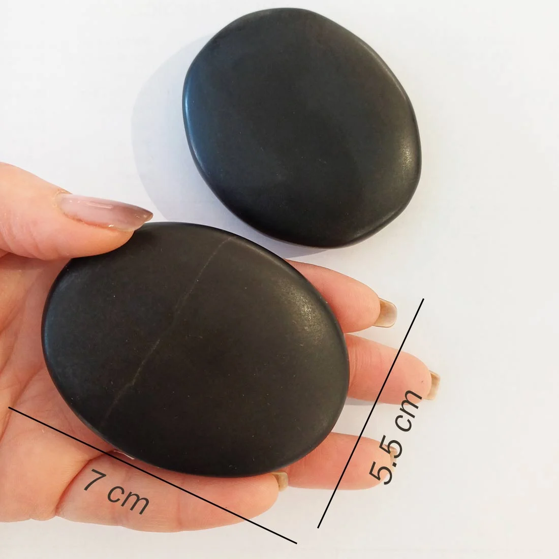 Basalt hot massage stones made from volcanic rock. Smooth polished stones that retain heat well, used for massage therapy, relaxation, and grounding practices
