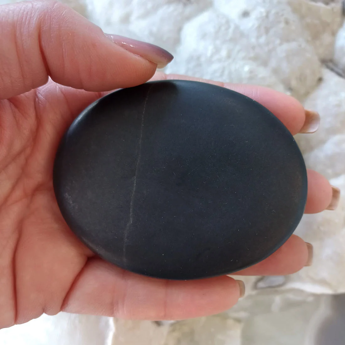 Basalt hot massage stones made from volcanic rock. Smooth polished stones that retain heat well, used for massage therapy, relaxation, and grounding practices