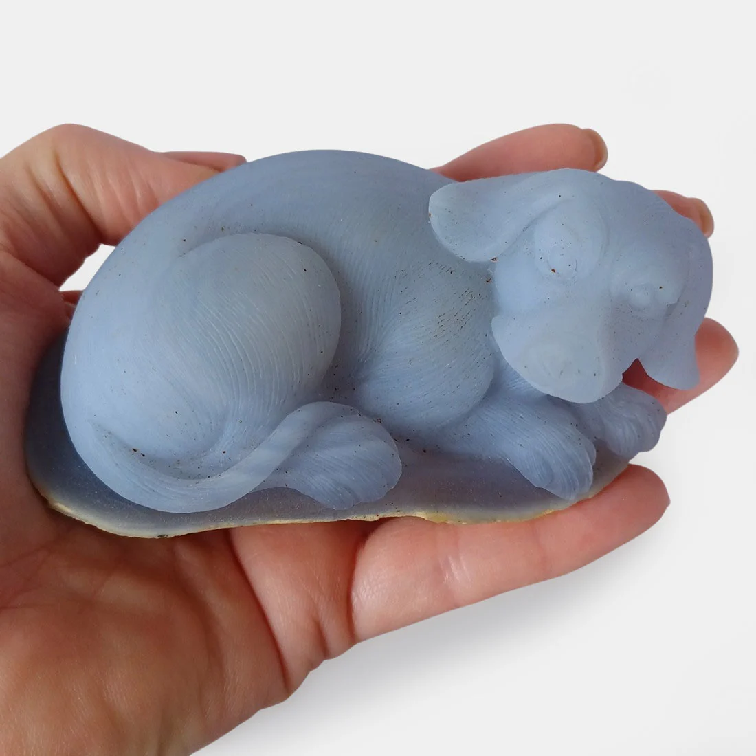 Chalcedony Resting Dog carving with smooth polished natural stone surface and soft mineral tones