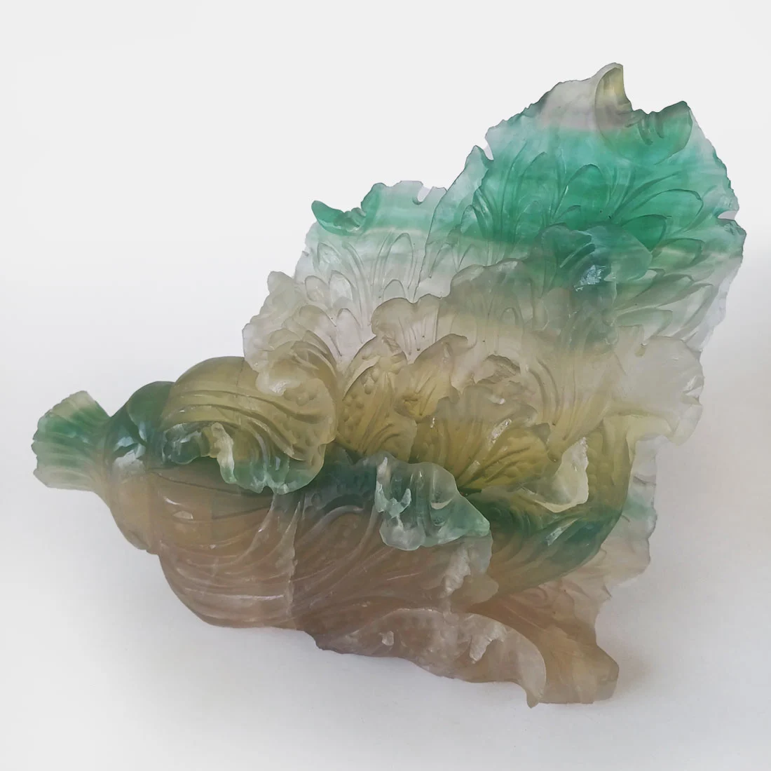 Green and cream Fluorite cornucopia crystal carving with detailed flowing carved patterns