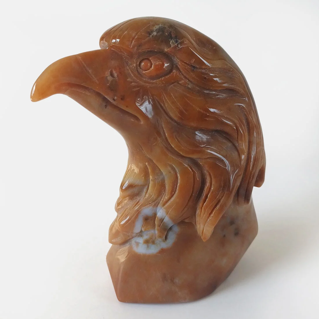 Hand carved Carnelian Eagle Head crystal carving with natural orange and brown patterns