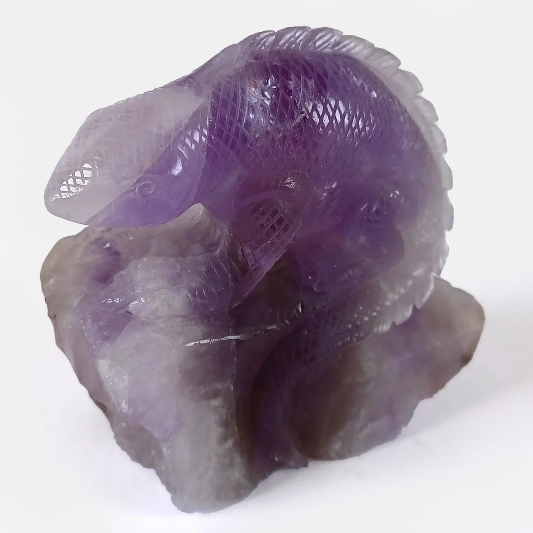 Hand-carved Amethyst Iguana carving symbolizing patience, adaptability, and balance. Natural amethyst crystal with unique purple tones.