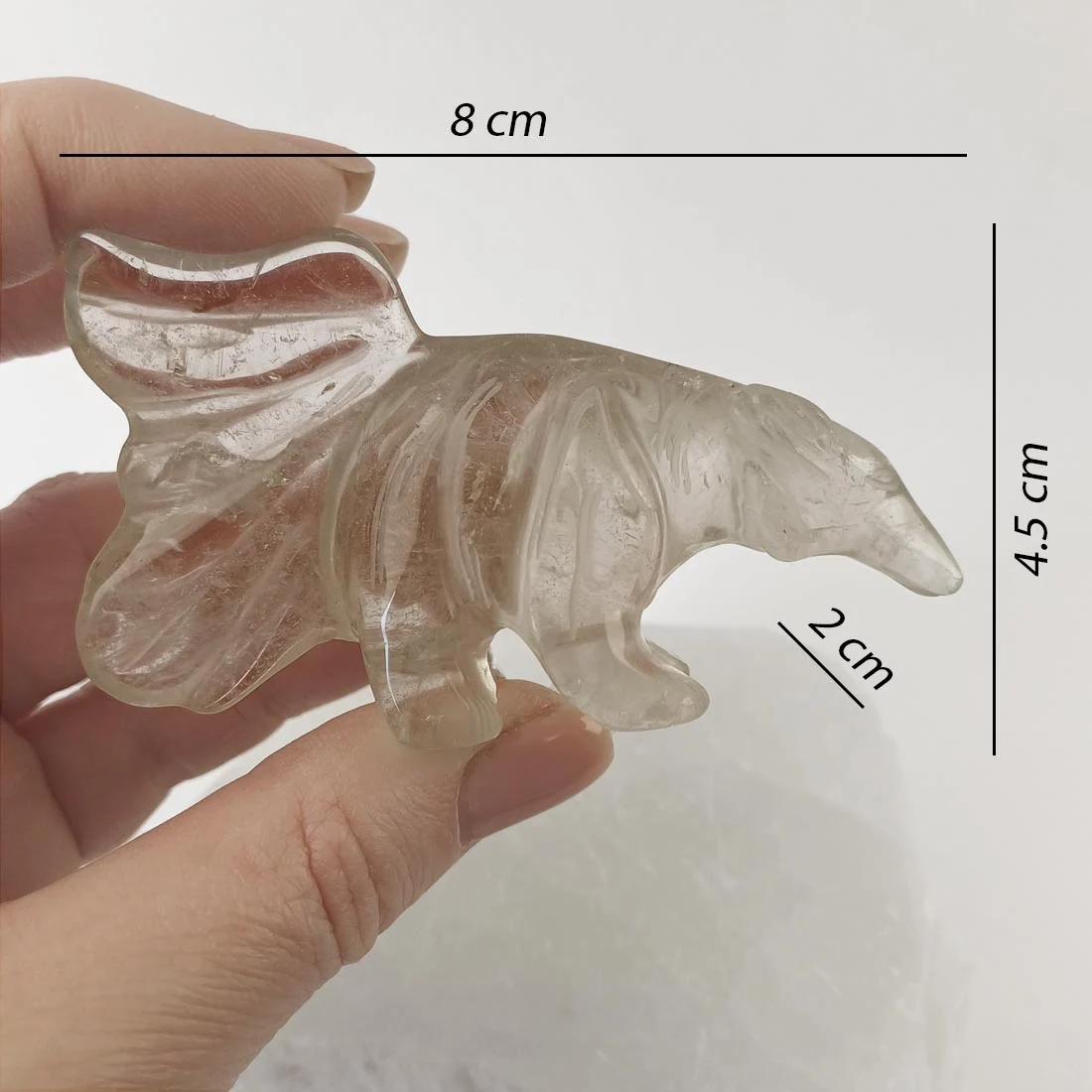 Hand-carved smoky quartz anteater with natural inclusions and soft transparency