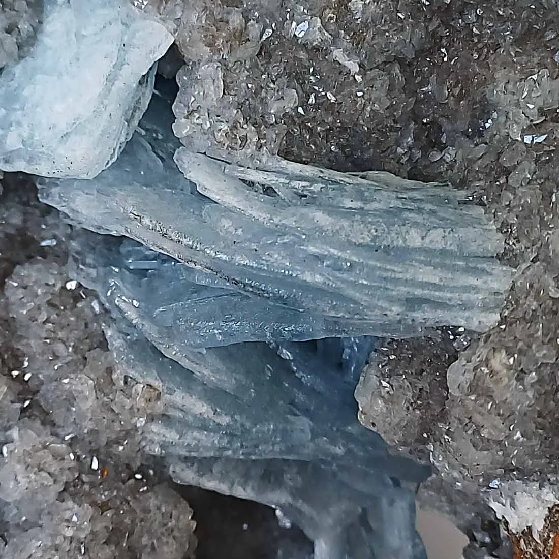 Blue Baryte crystals on quartz matrix with visible bladed crystal formations. - detail
