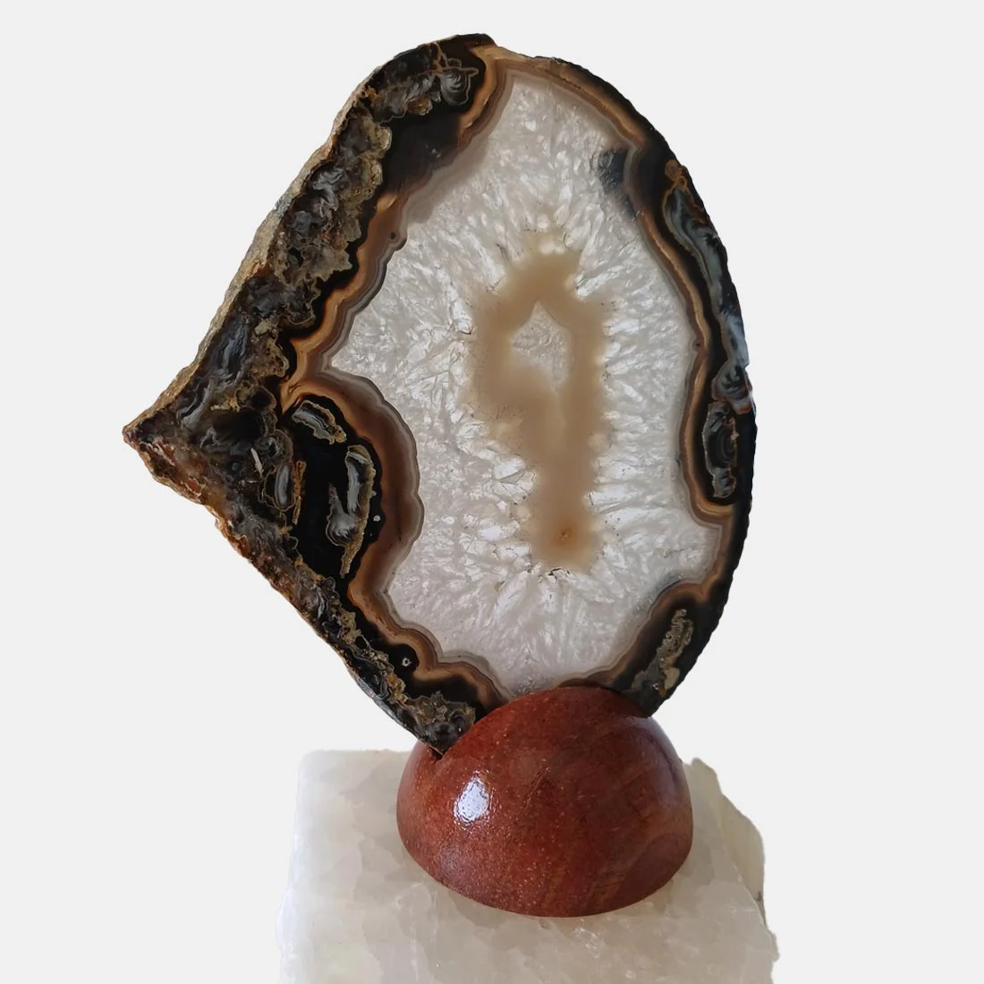 Natural agate slice rock on a removable wooden base.
