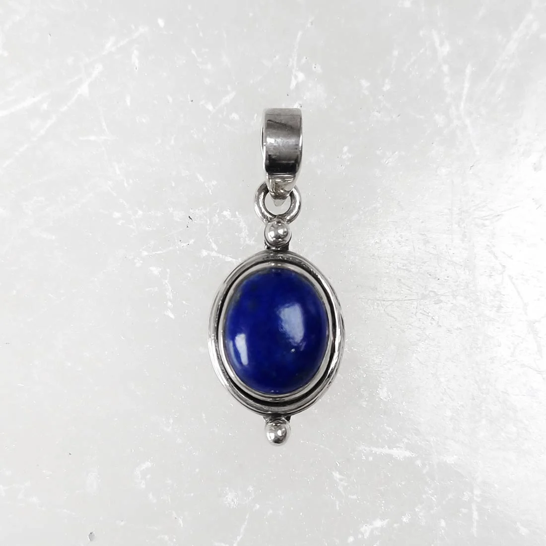 Oval lapis lazuli pendant set in 925 sterling silver with deep blue polished gemstone