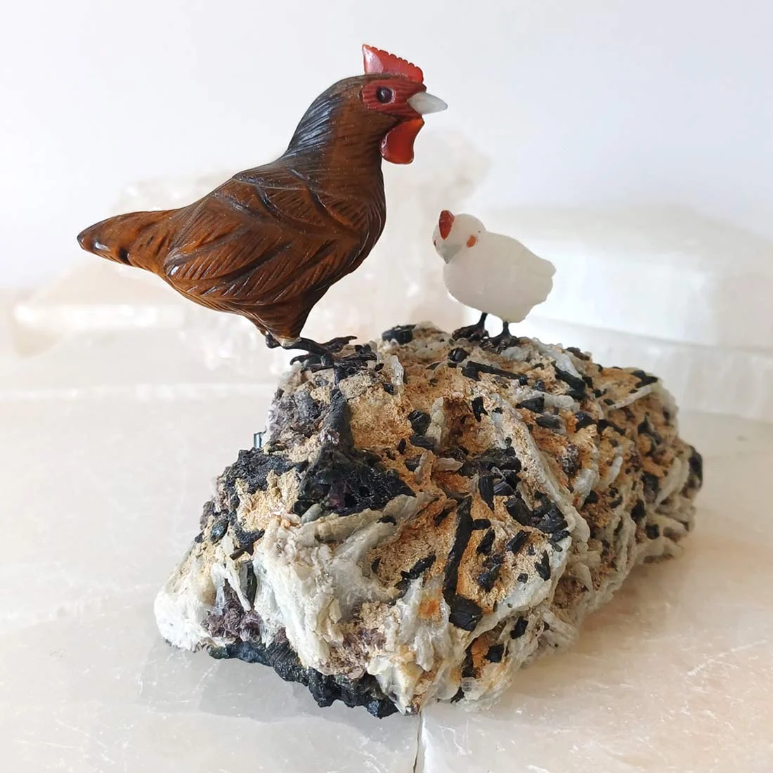 Tiger Eye and Milky Quartz chicken carvings by Peter Muller on a Black Tourmaline matrix.
