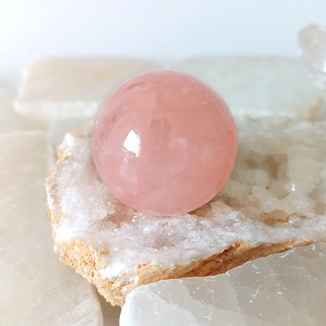 Rose Quartz Sphere – polished natural rose quartz associated with love and the Heart Chakra
